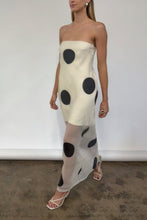 Load image into Gallery viewer, Woman wearing a chic Glam Expressway strapless dress with black polka dots against a plain background