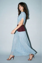 Load image into Gallery viewer, Model wearing a powder blue sleeveless mesh maxi dress with a mock neckline, burgundy ruched waistband, and flowing pleated skirt paired with burgundy heels.
