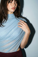 Load image into Gallery viewer, Model wearing a powder blue sleeveless mesh maxi dress with a mock neckline, burgundy ruched waistband, and flowing pleated skirt paired with burgundy heels.