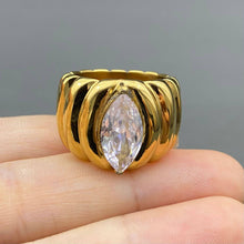 Load image into Gallery viewer, 18K gold-plated stainless steel statement ring with a large sparkling marquise-cut zircon center stone and sculpted ridged band.