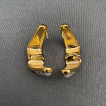 Load image into Gallery viewer, 18K gold-plated sculptural huggie earrings with four graduated white imitation pearl accents on each earring.