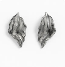 Load image into Gallery viewer, Textured sculpted silver wave earrings with organic curved shapes shown on a white background.