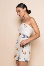 Load image into Gallery viewer, Model wearing a strapless white sequin mini dress featuring ocean-inspired seashell, starfish, and seahorse embellishments in a fitted bodycon silhouette.