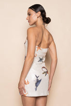 Load image into Gallery viewer, Model wearing a strapless white sequin mini dress featuring ocean-inspired seashell, starfish, and seahorse embellishments in a fitted bodycon silhouette.