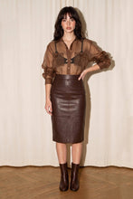 Load image into Gallery viewer, Woman wearing a sheer chocolate brown oversized organza button-down shirt layered over a camisole with leather skirt for a modern chic look.