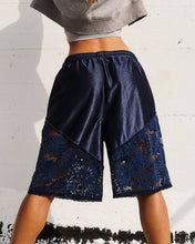 Load image into Gallery viewer, Navy blue shorts with lace detailing worn by a person against a light background