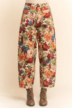 Load image into Gallery viewer, Floral tapestry cargo jogger pants with a high-rise fit, relaxed silhouette, and multicolor vintage-inspired print, styled with ankle boots.