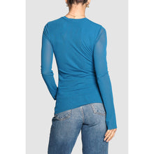 Load image into Gallery viewer, Person wearing a blue long-sleeve top and jeans on a light gray background