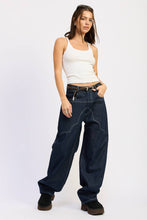 Load image into Gallery viewer, Woman wearing a white tank top and blue jeans on a white background