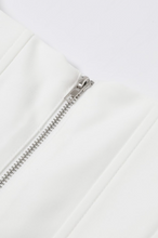 Load image into Gallery viewer, White structured bustier top featuring wide straps and multiple crystal floral embellishments across the front, photographed on a white background.