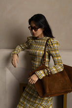 Load image into Gallery viewer, Yellow plaid smocked blouse with ruffle trim and long sleeves worn by model.