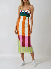 Load image into Gallery viewer, Woman wearing a colorful striped dress on a white background