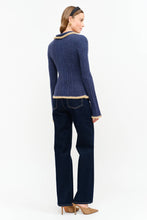 Load image into Gallery viewer, Model wearing The Aspen Double Zip Knit Cardigan in navy with contrast fuzzy trim, double zipper, flared sleeves, and wide-leg dark wash jeans.