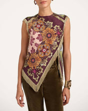 Load image into Gallery viewer, Model wearing a boho floral fringe scarf top with an asymmetrical handkerchief hem, vintage-inspired print in burgundy and olive tones, and decorative fringe trim.