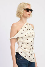 Load image into Gallery viewer, Woman wearing a one-shoulder polka dot top and sunglasses on a plain background