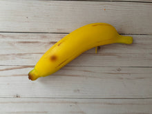Load image into Gallery viewer, Realistic banana-shaped coin purse with zipper, keychain ring, and bag charm attachment displayed on a wood background.