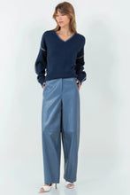 Load image into Gallery viewer, Introducing our Dusty Blue Loose Fit Vegan Leather Pants—a perfect blend of style and comfort. Crafted from high-quality vegan leather, these pants offer a soft, supple feel with a chic, relaxed silhouette. The loose fit provides ease of movement, making them ideal for both casual outings and dressed-up occasions. The unique dusty blue hue adds a modern twist to classic leather pants, ensuring you stand out in any crowd.