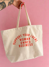 Load image into Gallery viewer, Natural cotton canvas tote bag with red "Support Your Local Woman-Owned Business" graphic displayed against a clean white background.