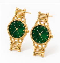 Load image into Gallery viewer, Gold statement earrings designed like miniature vintage watches with emerald-green faces, gold hands and bracelet-style detailing.