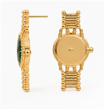 Load image into Gallery viewer, Gold statement earrings designed like miniature vintage watches with emerald-green faces, gold hands and bracelet-style detailing.