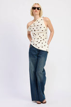 Load image into Gallery viewer, Woman wearing a polka dot top and blue jeans on a white background