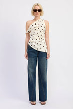 Load image into Gallery viewer, Woman wearing a polka dot top and blue jeans on a white background