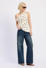 Load image into Gallery viewer, Woman wearing a polka dot top and blue jeans on a white background