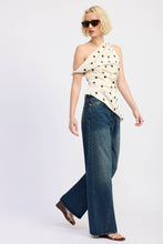 Load image into Gallery viewer, Woman wearing a polka dot top and blue jeans on a white background