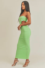 Load image into Gallery viewer, This Lime green strapless maxi dress is made from a soft and stretchy material that will conform to your curves. Its cutouts and strapless detail make for a sexy silhouette, perfect for a summer wedding or night out on the town. A solid dress with cutouts on the sides. This strapless dress has a tight cup fit and plenty of stretch. Model pictured is wearing a size small.