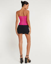 Load image into Gallery viewer, Add some sparkle to your party outfit with our Pink Rhinestone Corset Tube Top. This glamorous "going out top" comes in a pink stretch tailoring fabric, features a slim fit with a bandeau neckline and zipper fastening at the back. Finished with a rhinestone crystal trim detailing. Style Tip: Wear our Pink Rhinestone Corset Top with oversized cargo pants for chic city streetwear look or pair it with some tailored wide leg pants and strappy heels for a dressier moment.