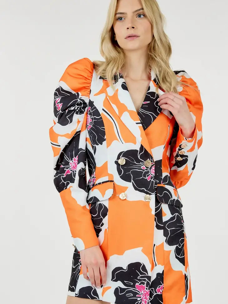 Glam Expressway's Orange puff sleeve Blazer Dress is a show stopper! This dress is orange and printed with black and white florals. This fun dress is double breasted with gold toned buttons and a pop of color for an elevated look. Wear this gorgeous and stylish dress to dinner parties and rooftops all Summer long!