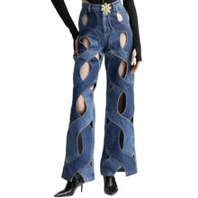 Load image into Gallery viewer, Glam Expressway&#39;s Criss Cross Jeans are unique, cool and attention grabbing. These two tone denim jeans have an open criss cross pattern with cutouts throughout. They come with a removable gold flower pendants and a cute heart shape designed on the back. These jeans have no stretch so if uncertain about size, it is best to size up. These stylish jeans can be dressed up or down! 
