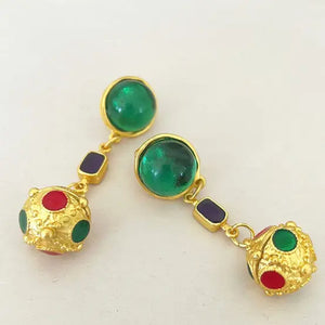 Turn heads with these Ball Drop Statement Earrings. Featuring a large green Gripoix-style stone at the top, accented with blue and green details, these stunning pierced dangle earrings are perfect for any occasion. Measuring approximately 2.25" tall x 0.50" wide, they add a touch of elegance to your ensemble.