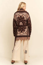 Load image into Gallery viewer, Chocolate brown tapestry-inspired jacquard knit cardigan with shawl collar, self-tie belt and multicolor fringe trim.
