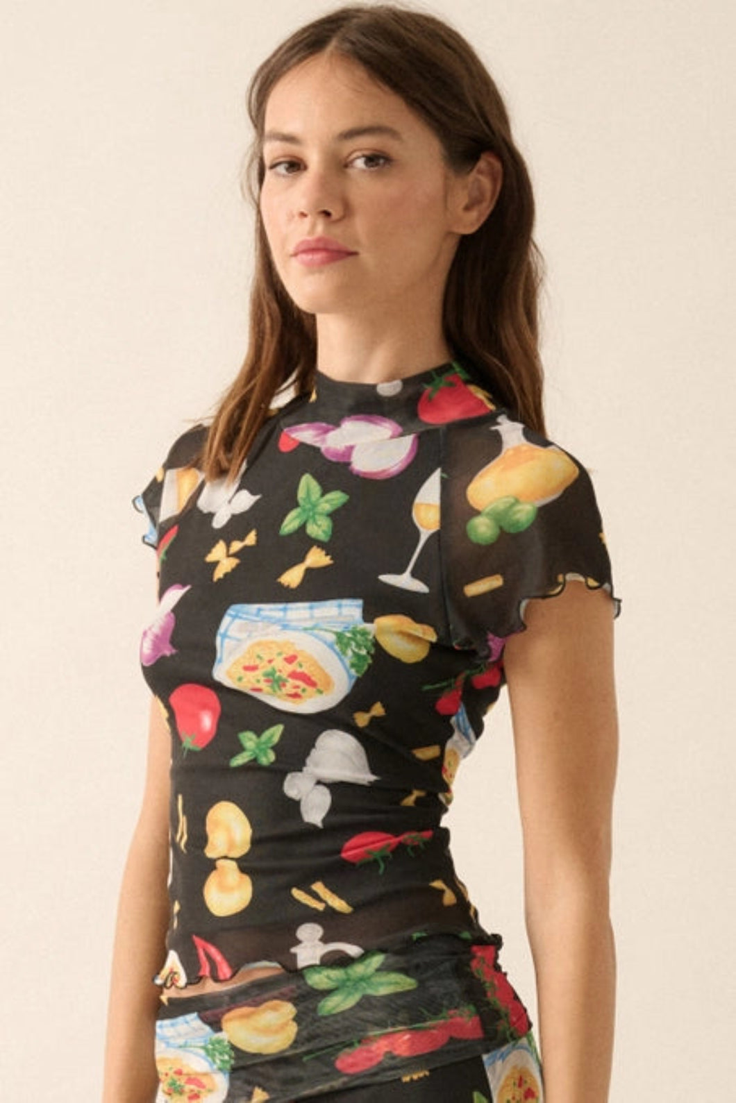 Model wearing the colorful Italian food print mesh set from Glam Expressway, featuring a fitted long sleeve crop top and a high-waisted foldover waistband maxi skirt with pasta, pizza, and tomato motifs — perfect for bold, statement resort wear or summer styling.
