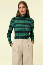 Load image into Gallery viewer, Our Green Dyed Long Sleeve Top is ribbed with a high neck and a beautiful Kelly green and black tie dye fabric. This long sleeve shirt has lots of stretch, thin and soft ribbed fabric, and hits to just below the waist. The Green Dyed Long Sleeve Top can be worn to work with a pair of trousers or on the weekend with a maxi skirt. This all weather, all season top looks chic tucked in or worn out so the styling options are endless. 

