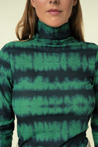 Our Green Dyed Long Sleeve Top is ribbed with a high neck and a beautiful Kelly green and black tie dye fabric. This long sleeve shirt has lots of stretch, thin and soft ribbed fabric, and hits to just below the waist. The Green Dyed Long Sleeve Top can be worn to work with a pair of trousers or on the weekend with a maxi skirt. This all weather, all season top looks chic tucked in or worn out so the styling options are endless. 