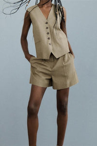 This Khaki vest and shorts set is a simple, classic and chic outfit. The khaki vest has side pockets and the matching shorts come with a brown woven adjustable belt. You can style this set with your favorite pair of sandals or sneakers. The Kahaki Vest & Shorts Set gives a safari chic vibe. Perfect on its own or layered over a long sleeved top or sweater. This khaki set is perfect for your next adventure. Simply throw on this outfit and you're ready to go.