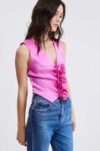 Introducing our Pink Rosette Satin Vest Top - Our take on a Y2K-inspired vest. Crafted from a solid satin fabric with exquisite rosette bud detailing on the front, it adds a trendy twist to a classic style. The V neckline, pointed front hem, and cropped fit embrace the perfect blend of contemporary and timeless charm. Pair this charming vest with denim or trousers to complete the look! Model is wearing a size Small. Dress it up or  down!