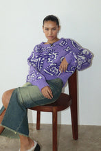 Load image into Gallery viewer, Stay cozy and comfortable in this colorful bandana-inspired sweater. Featuring a relaxed fit, this piece can be dressed up or down as desired. Show off your vibrant, trendy style in this cozy, soft purple paisley printed sweater. It’s the perfect piece to wear around town on a cold day, whether you&#39;re out with friends or relaxing at home.
