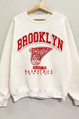 Score major style points in our Cream Brooklyn Sweatshirt! This oversized, vintage-athletic inspired crewneck features a cool 