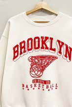 Load image into Gallery viewer, Score major style points in our Cream Brooklyn Sweatshirt! This oversized, vintage-athletic inspired crewneck features a cool &quot;Brooklyn Basketball&quot; graphic. Soft, comfy, and perfect for a laid-back look!
