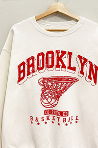 Score major style points in our Cream Brooklyn Sweatshirt! This oversized, vintage-athletic inspired crewneck features a cool "Brooklyn Basketball" graphic. Soft, comfy, and perfect for a laid-back look!