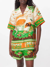 Load image into Gallery viewer, Elevate your summer style with the Peponi Tropical Shorts and Shirt Set. This vibrant ensemble features a stunning tropical island sunset print in shades of green, beige, white, brown, and orange. Perfect for warm weather, the breezy blouse and matching shorts capture the essence of an exotic getaway, making it a must-have for your wardrobe.
