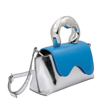 Load image into Gallery viewer, Meet our Silver and Blue Top Handle Bag, one of the most unique and intricate handbags you will find. Made out of recycled vegan leather this metallic top handle bag makes a fashionable yet sustainable statement piece. Wear it comfortably as a crossbody bag using the adjustable strap for hands-free convenience.
