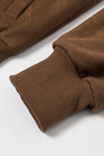 Load image into Gallery viewer, Close-up of brown knitted sleeves on a white background
