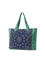 Load image into Gallery viewer, Oversized navy and green cotton canvas tote featuring a patchwork bandana paisley print, green side panels and matching shoulder straps on a white background.
