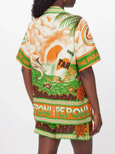 Load image into Gallery viewer, Elevate your summer style with the Peponi Tropical Shorts and Shirt Set. This vibrant ensemble features a stunning tropical island sunset print in shades of green, beige, white, brown, and orange. Perfect for warm weather, the breezy blouse and matching shorts capture the essence of an exotic getaway, making it a must-have for your wardrobe.
