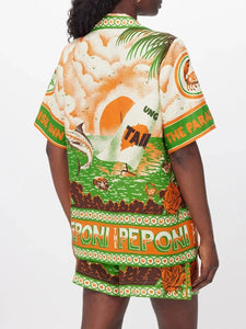 Elevate your summer style with the Peponi Tropical Shorts and Shirt Set. This vibrant ensemble features a stunning tropical island sunset print in shades of green, beige, white, brown, and orange. Perfect for warm weather, the breezy blouse and matching shorts capture the essence of an exotic getaway, making it a must-have for your wardrobe.