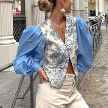 Load image into Gallery viewer, Introducing our Blue Puff Sleeved Floral Paneled Blouse – where chic meets elegance. Featuring a flattering V-neck and stylish puff sleeves, this blouse exudes sophistication with every detail. Perfect for any occasion, it’s a must-have addition to your wardrobe. Shop now before they’re gone!
